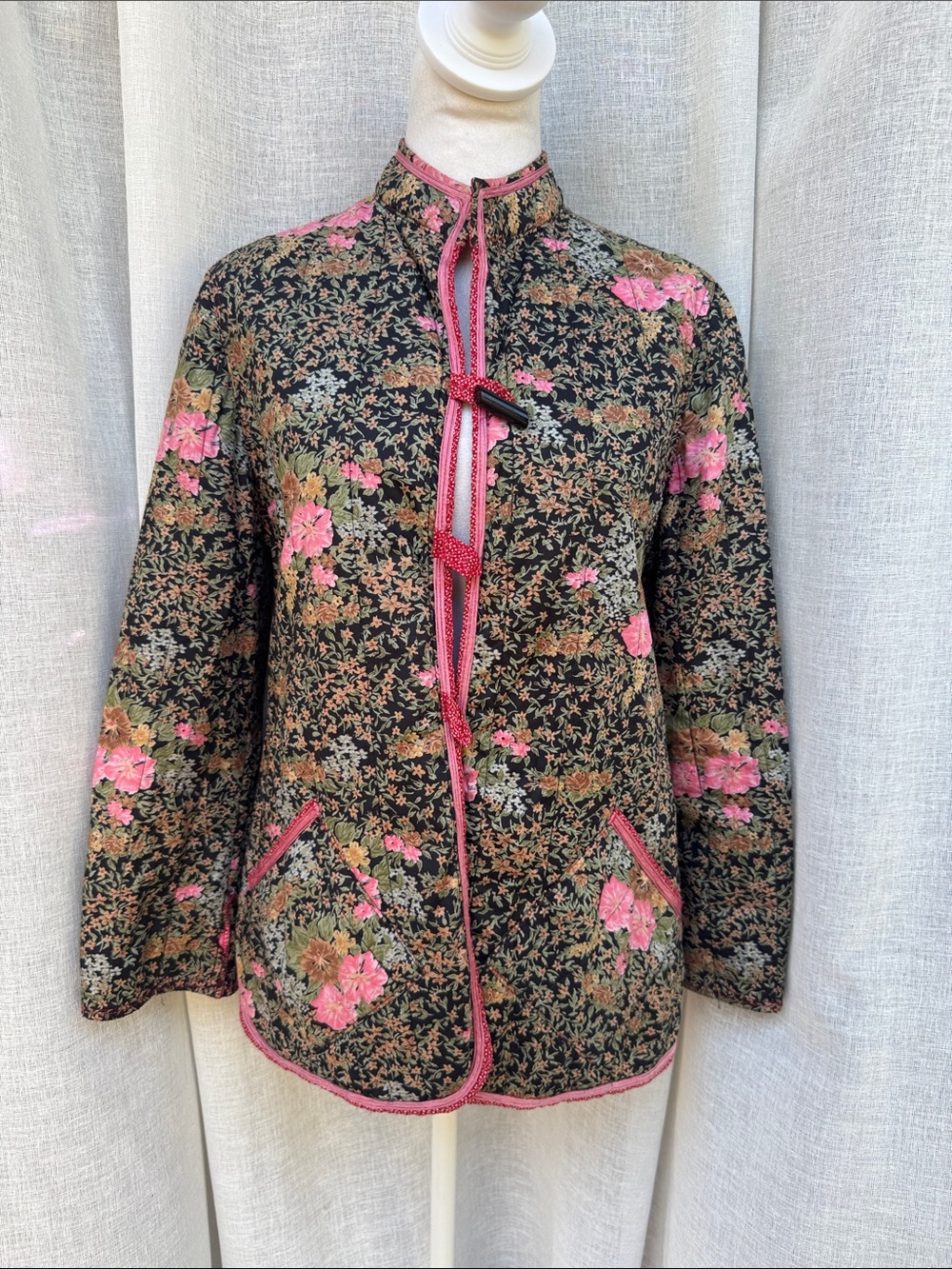 1970 CM vintage quilted cotton jacket with a dark floral pattern and pink trim
